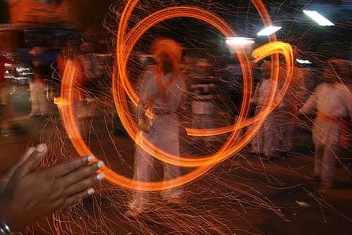A maori practitioner fire spinning the poi 