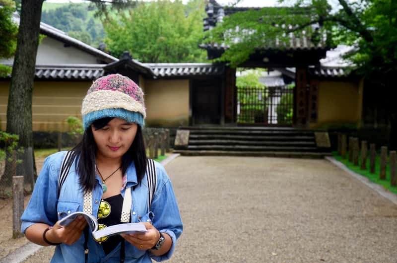 Woman Reading Guide Book