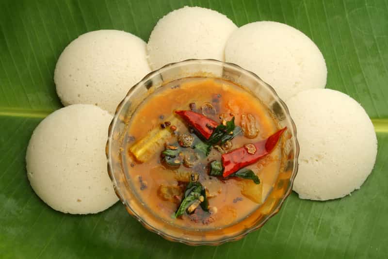 Idli served on a banana leaf