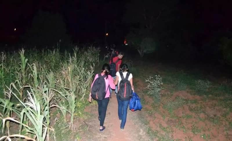  Trekkers going through a field in Ramanagara