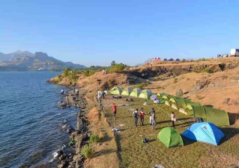 Visitors camping by the Bhandardara Lake camp