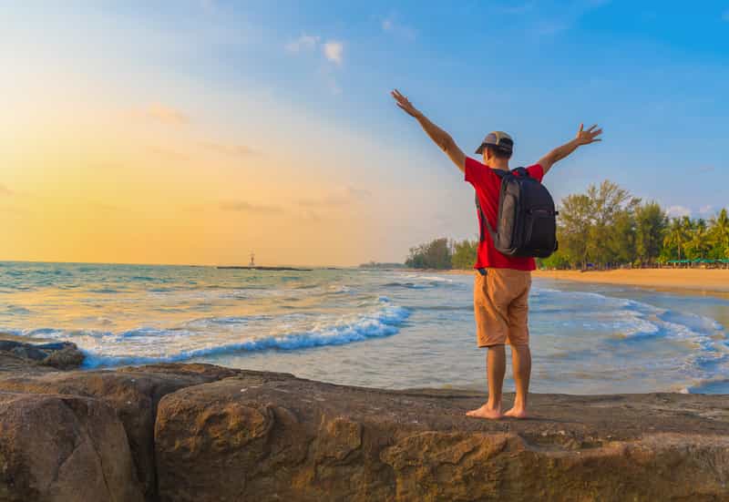 A tourist trekking at the beach